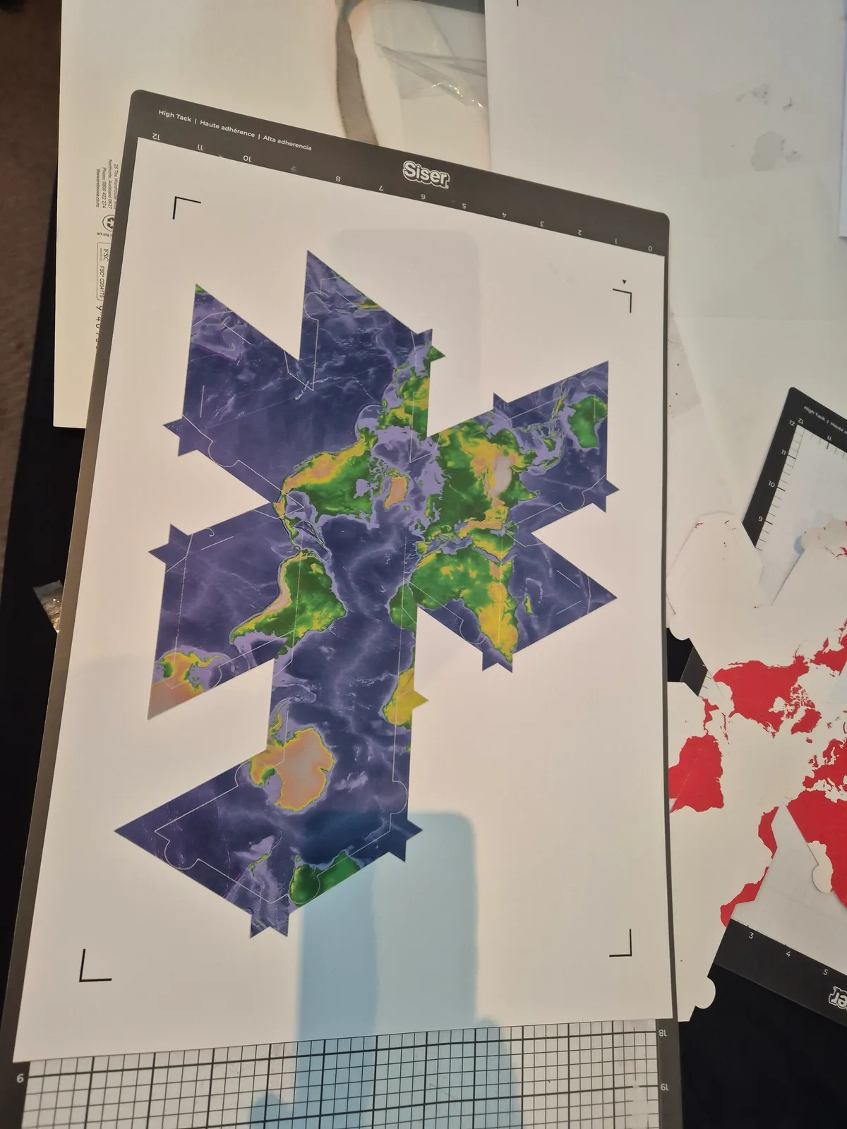 A colour map on a cutting mat, laid out as the twenty triangular faces of an unfolded globe.